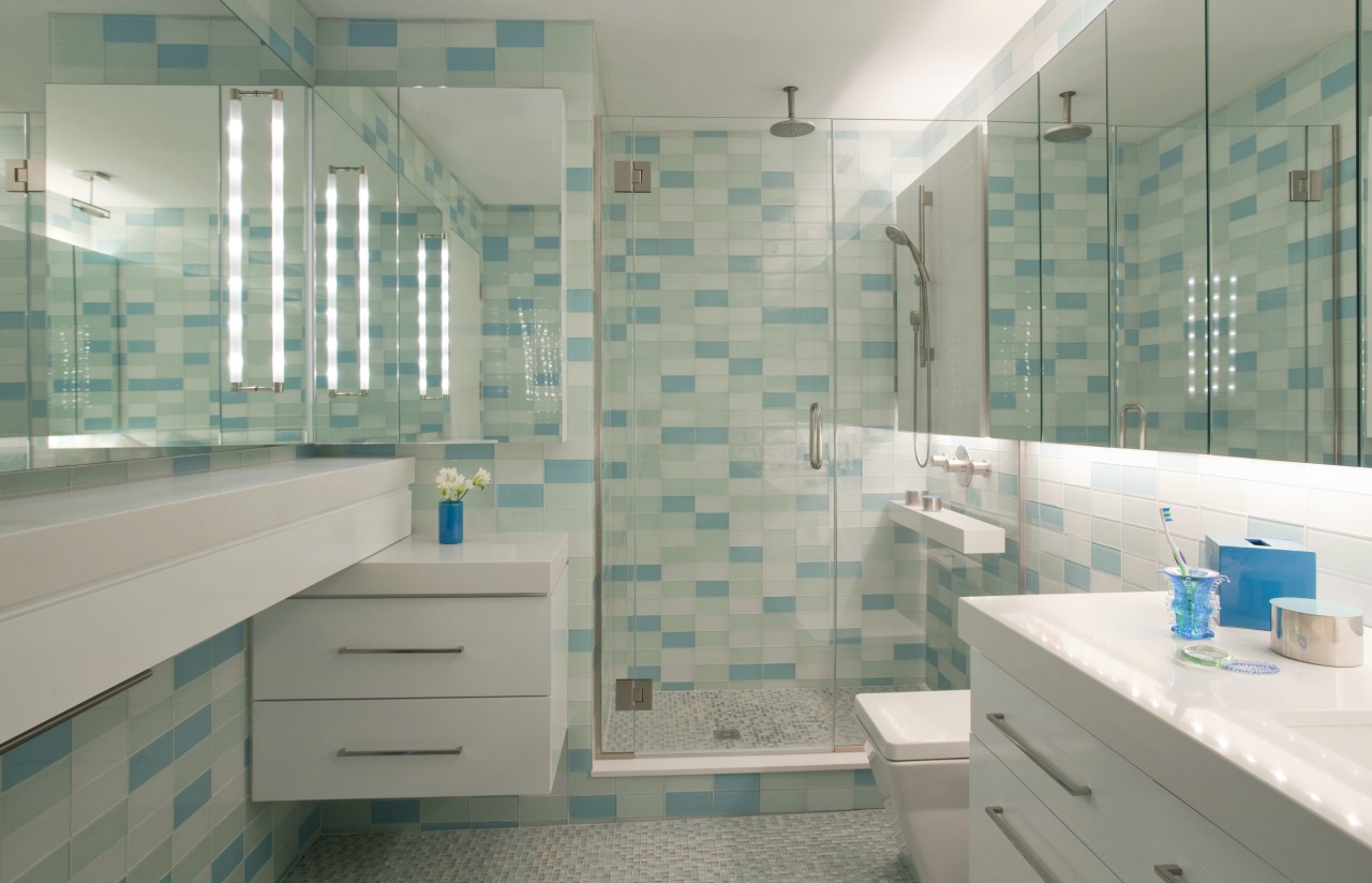 A line of mirrors bounces light around this bathroom, floor, glass, home, interior design, room, tile, gray, green