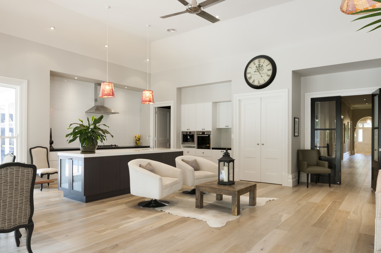 This contemporary open-plan kitchen and living area by ceiling, floor, flooring, hardwood, interior design, laminate flooring, living room, real estate, room, wood flooring, gray