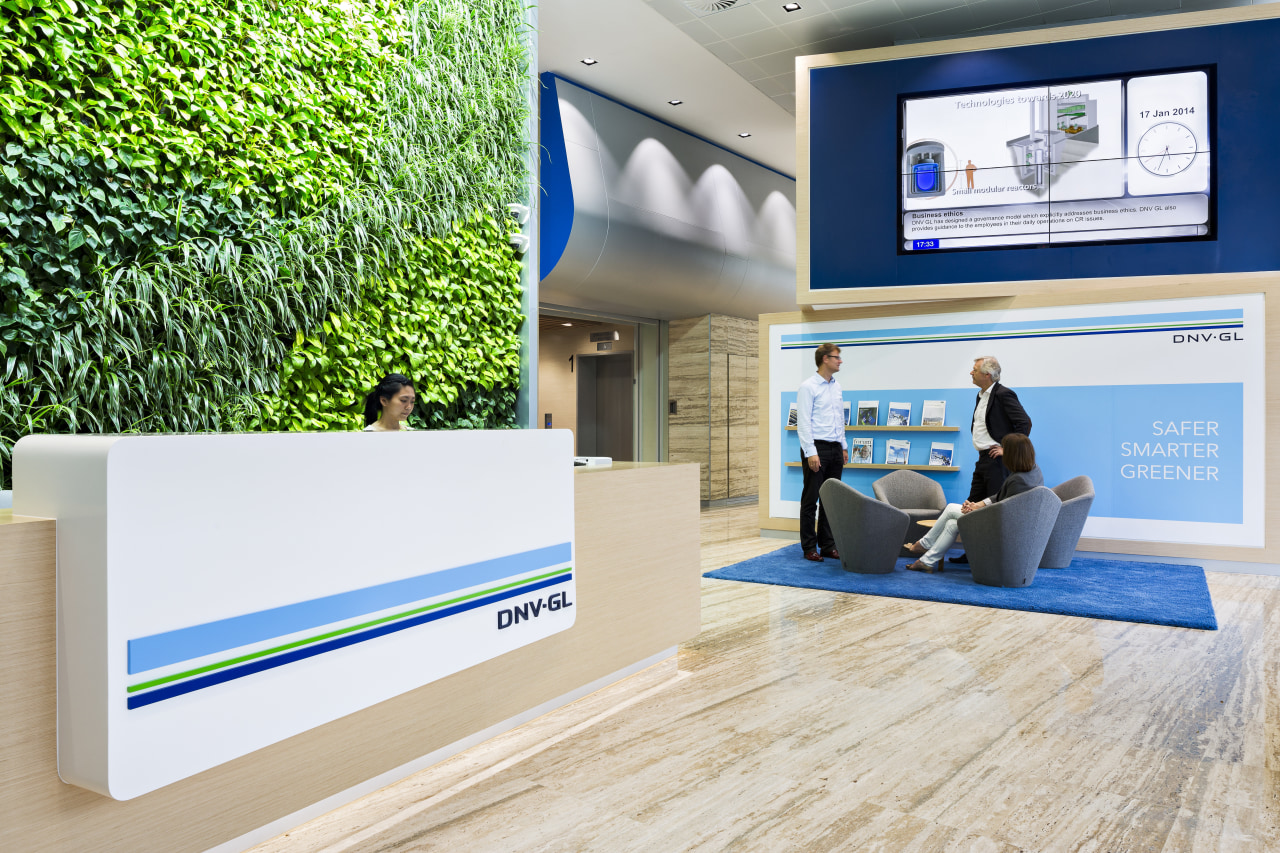 This reception area with green wall, customer seating floor, flooring, interior design, product design, gray