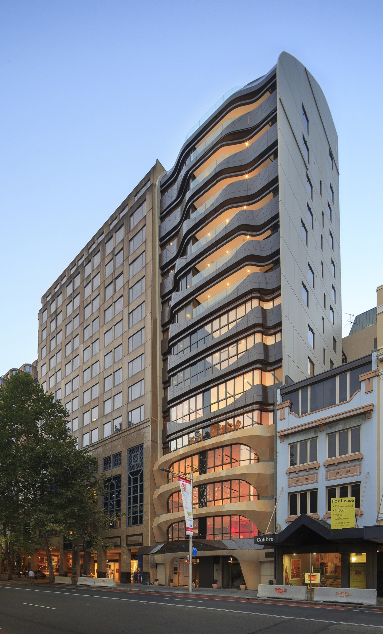 The tessellated facade of Eliza Apartments features sandstone apartment, architecture, building, city, commercial building, condominium, corporate headquarters, daytime, downtown, facade, headquarters, hotel, metropolis, metropolitan area, mixed use, neighbourhood, real estate, residential area, sky, skyscraper, tower block, urban area, window, teal