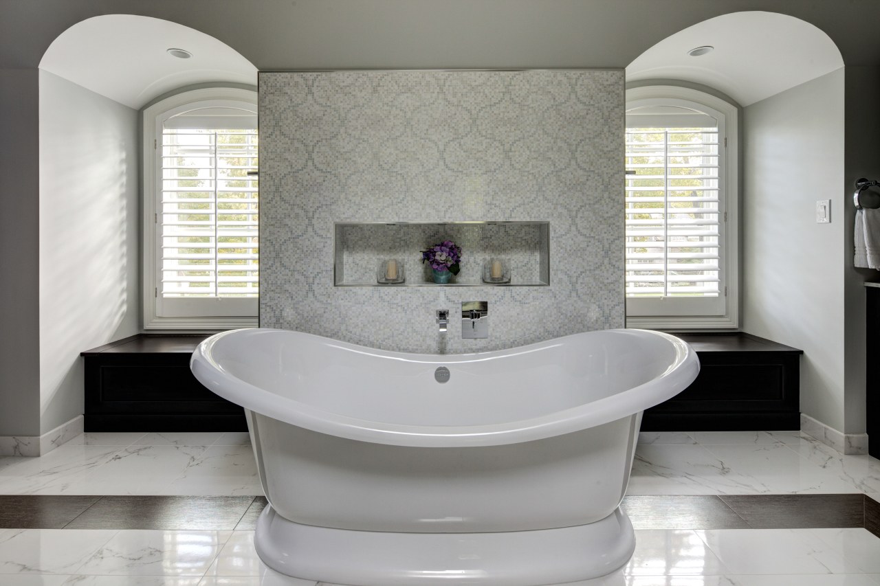 A traditionally styled bathtub enhances the sense of bathroom, bathroom accessory, bathtub, floor, interior design, plumbing fixture, product design, room, sink, tap, gray