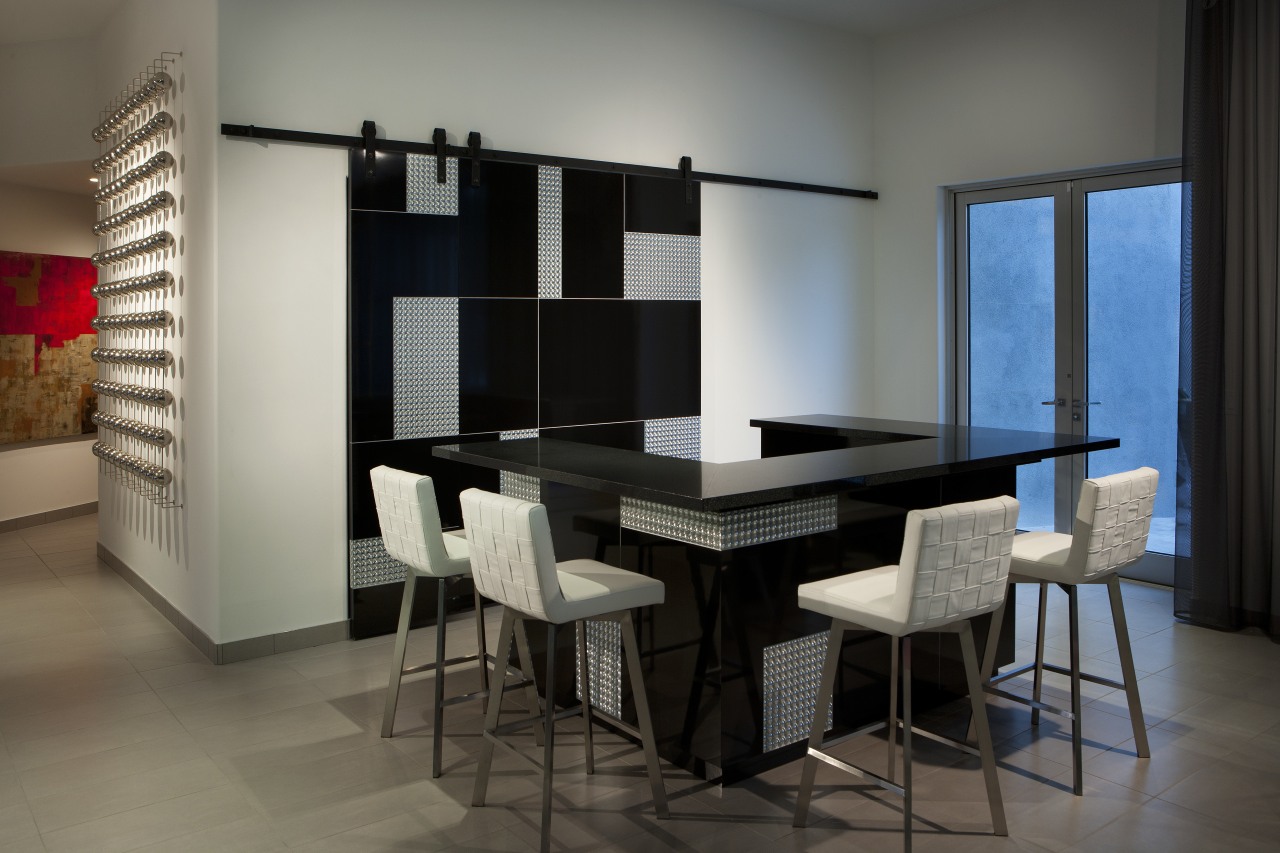 Sliding doors conceal part of this glittering bar dining room, furniture, interior design, room, table, gray, black