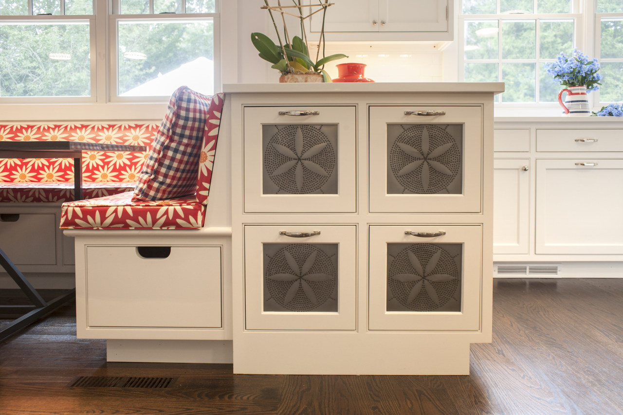 A small peninsula beside a banquette seating area cabinetry, chest of drawers, drawer, floor, flooring, furniture, hardwood, wood stain, white, brown