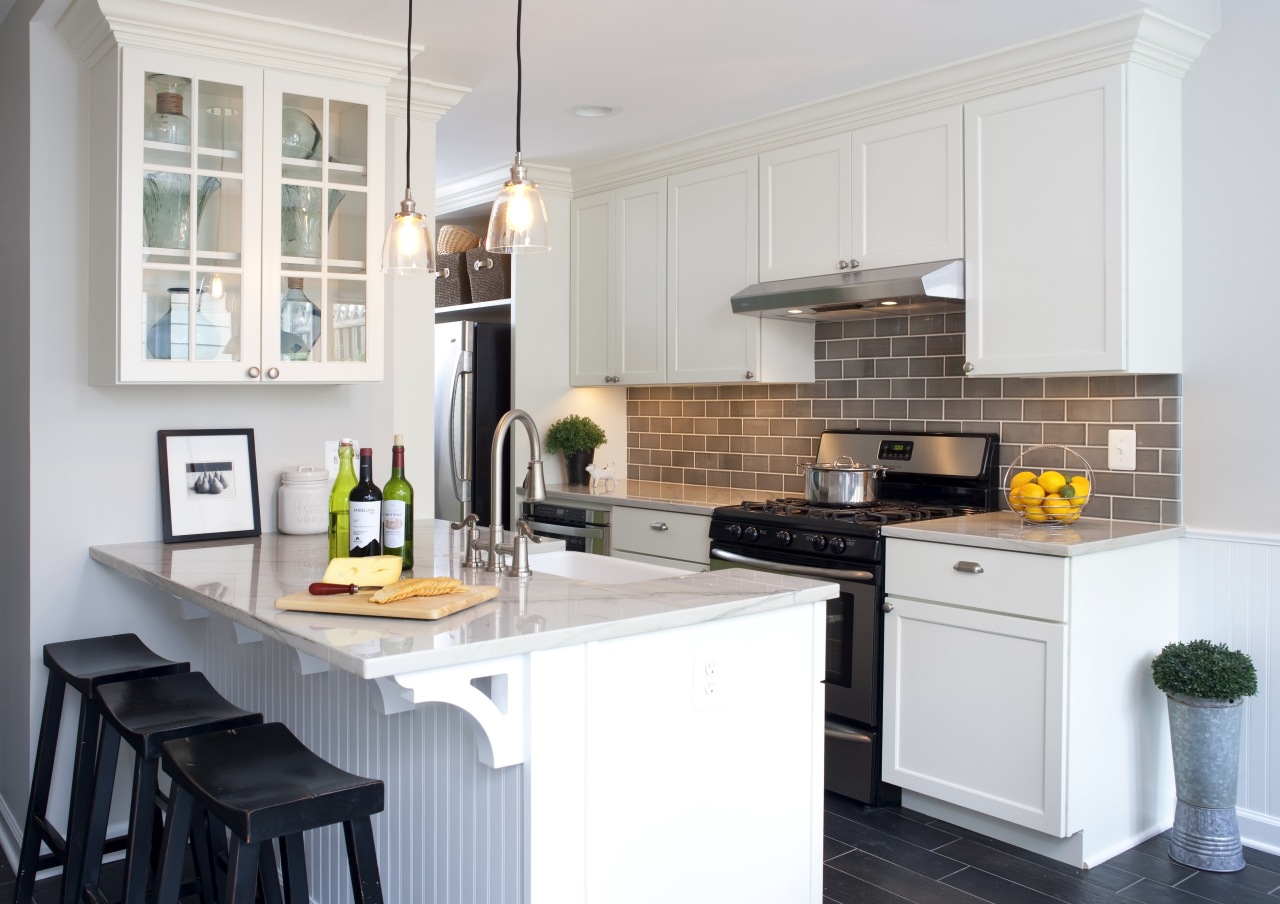 A peninsula forms the centerpiece of this remodeled cabinetry, countertop, cuisine classique, home, interior design, kitchen, room, white, gray