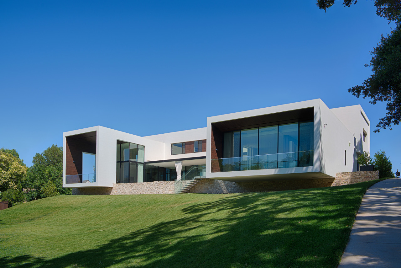 Cantilevered wings project out over the ridge on architecture, building, corporate headquarters, cottage, daytime, elevation, estate, facade, home, house, property, real estate, residential area, sky, villa, window, teal