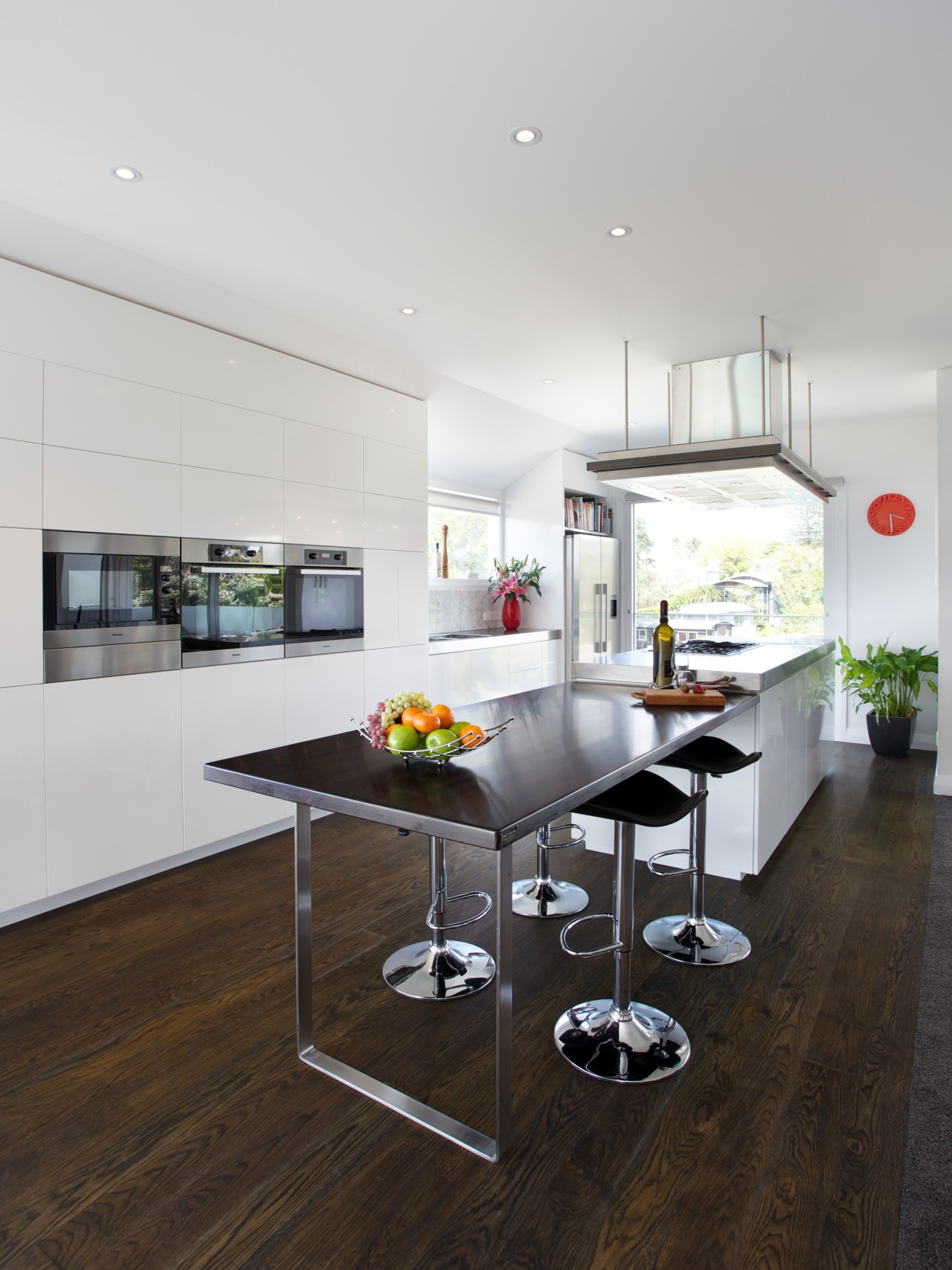 This contemporary kitchen, designed and manufactured by Mastercraft architecture, countertop, floor, flooring, house, interior design, kitchen, real estate, table, white, black