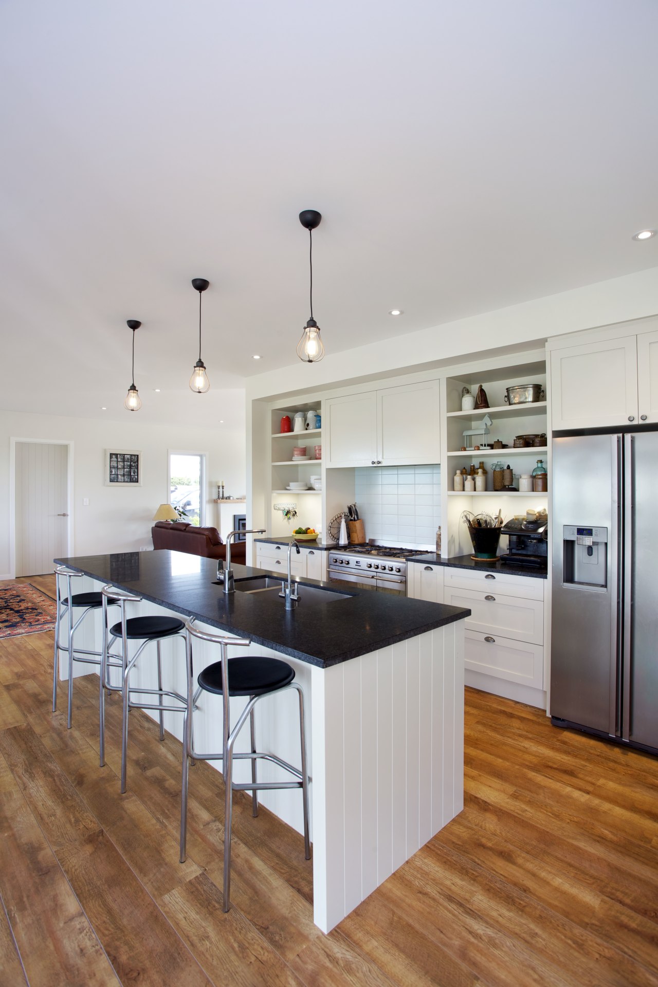 This traditionally styled kitchen, designed and manufactured by countertop, floor, flooring, hardwood, interior design, kitchen, room, wood flooring, gray