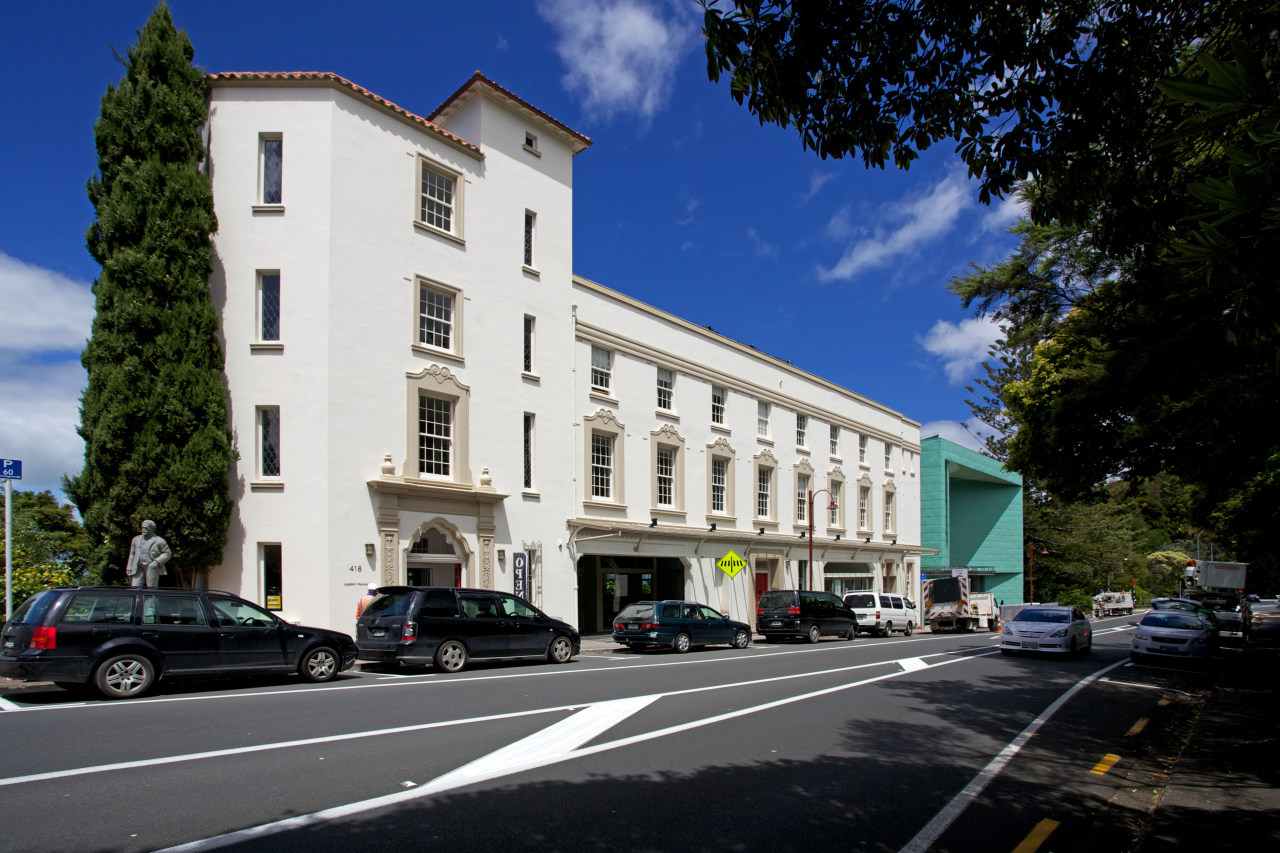 Te Uru Waitakere is a new art gallery architecture, building, car, city, downtown, estate, facade, family car, home, house, infrastructure, luxury vehicle, metropolitan area, mixed use, neighbourhood, property, real estate, residential area, road, sky, street, town, black