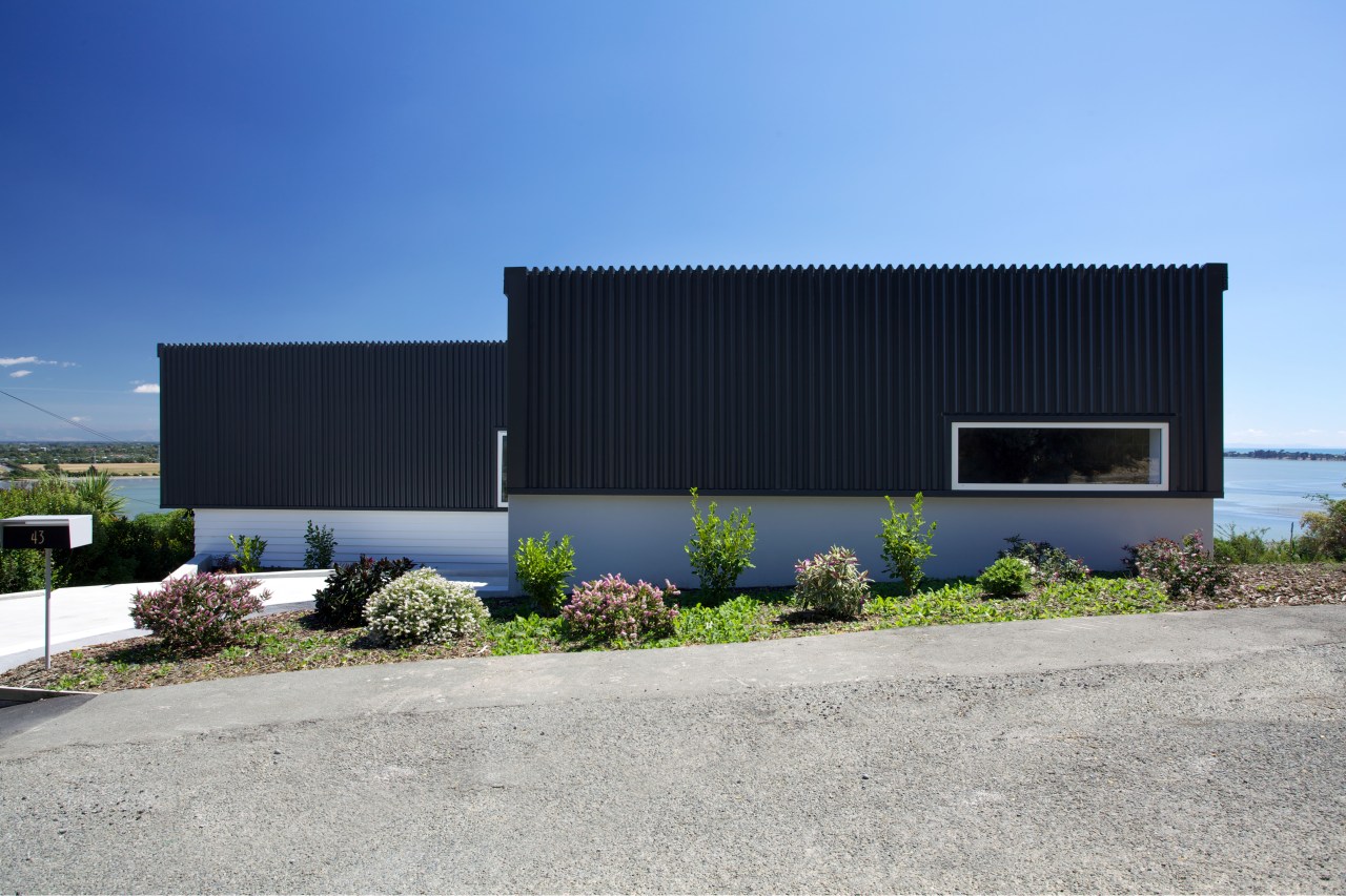 Designed by Archimetrix, a Christchurch-based consultancy, this new architecture, building, commercial building, corporate headquarters, facade, home, house, property, real estate, shed, sky, teal, gray