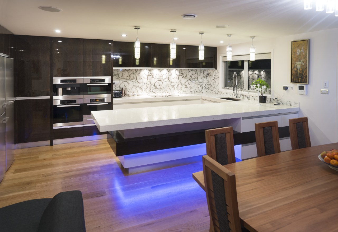 Dark wood veneer contrasts white lacquered cabinetry in countertop, floor, flooring, hardwood, interior design, kitchen, room, table, wood, wood flooring, gray