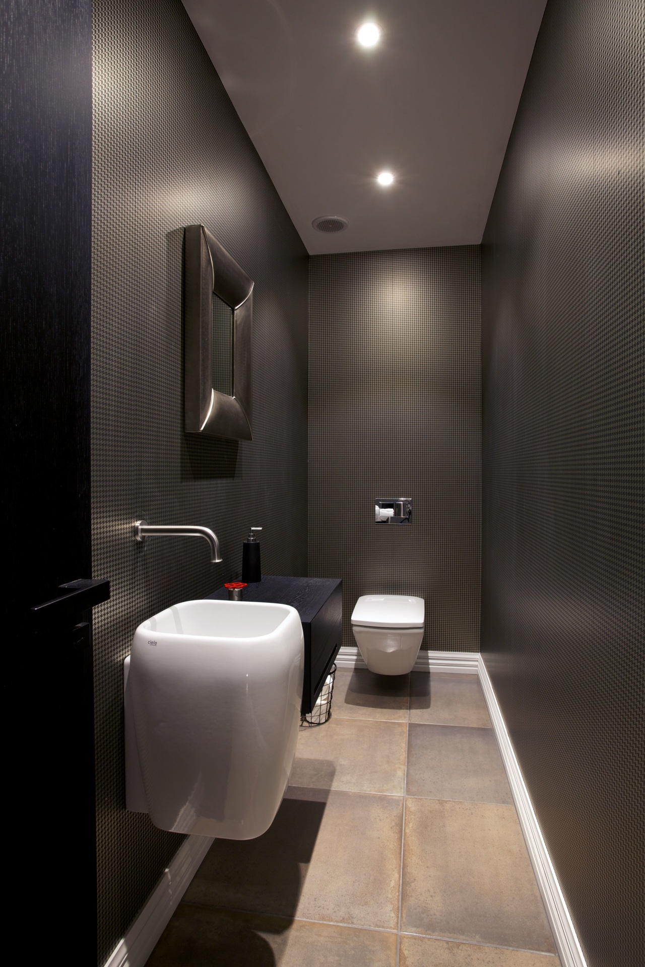 A dark houndstooth-patterned wallpaper enhances the intimate feel architecture, bathroom, ceiling, floor, interior design, lighting, plumbing fixture, product design, public toilet, room, toilet, black, gray