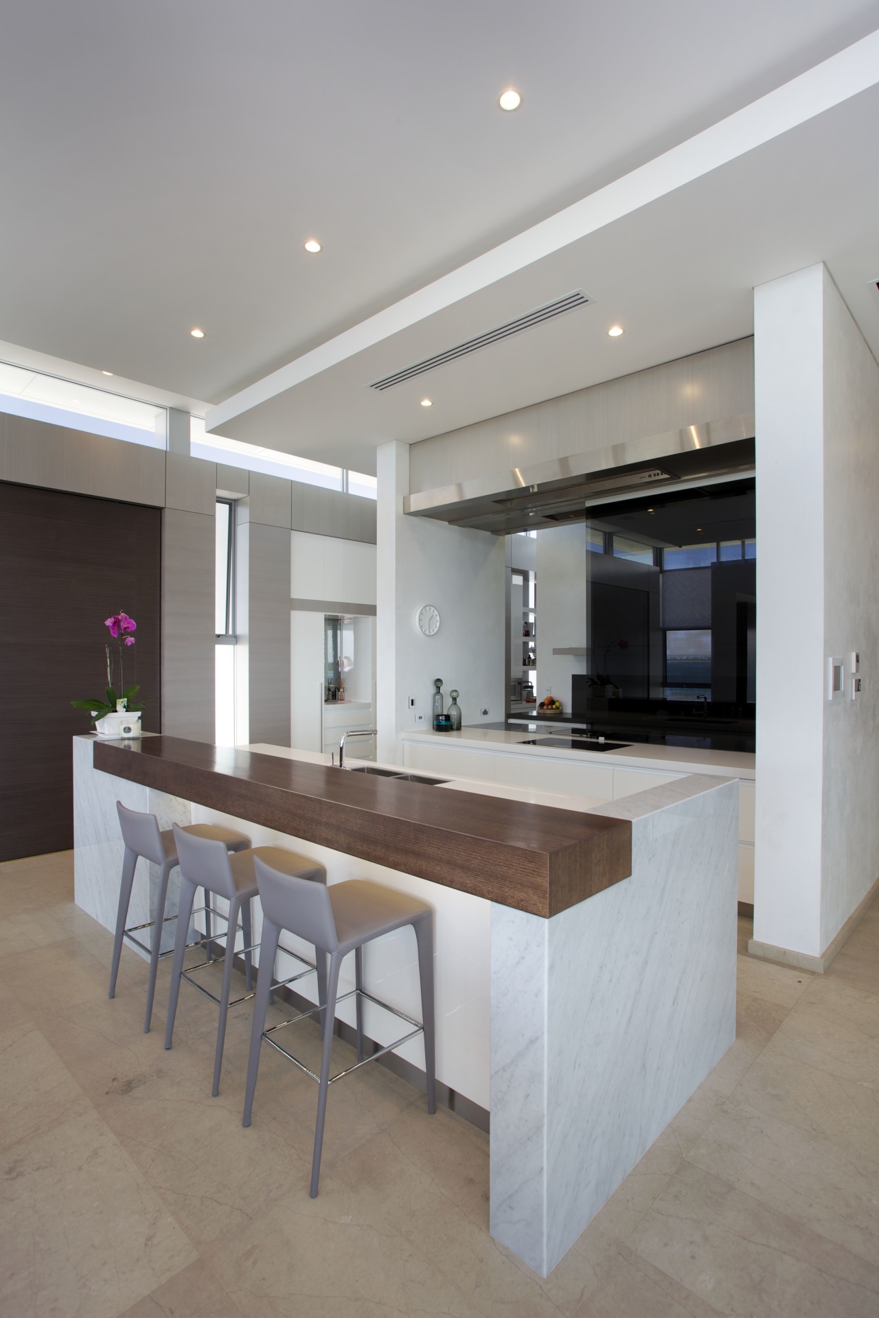 This kitchen, designed by Leon House, reinforces the ceiling, countertop, floor, flooring, interior design, kitchen, real estate, table, gray