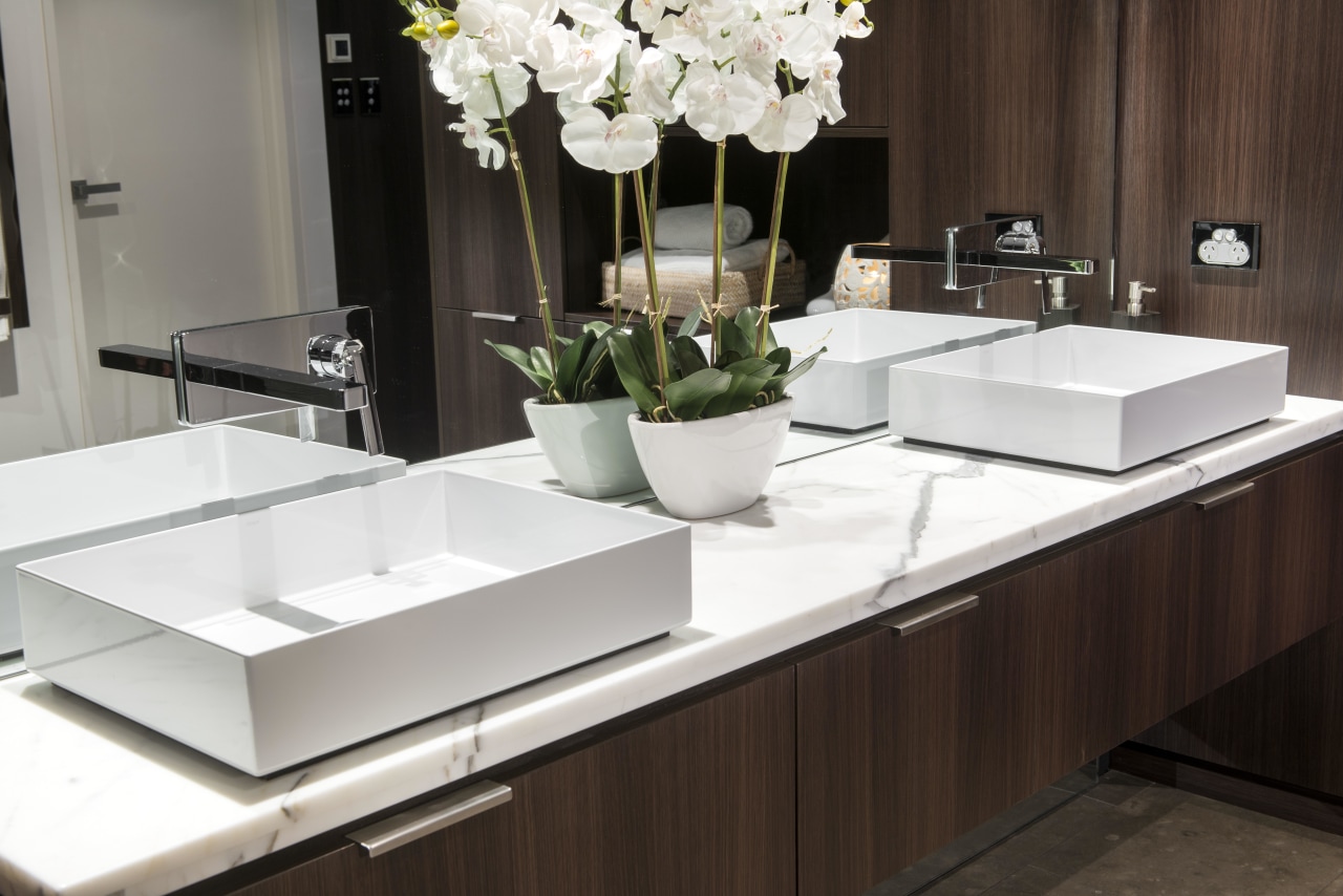 Modern, geometric basins offset wood veneers and neutral coffee table, countertop, furniture, interior design, product design, sink, table, tap, black, white