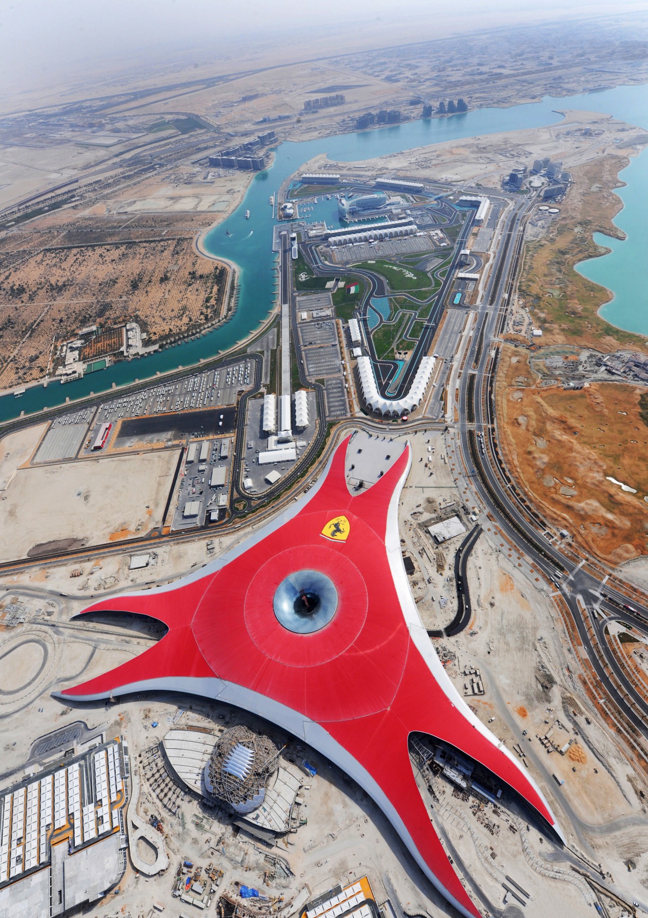 The Ferrari Theme Park features Euramax colour-coated aluminium aerial photography, bird's eye view, city, fixed link, sky, urban area, water, gray