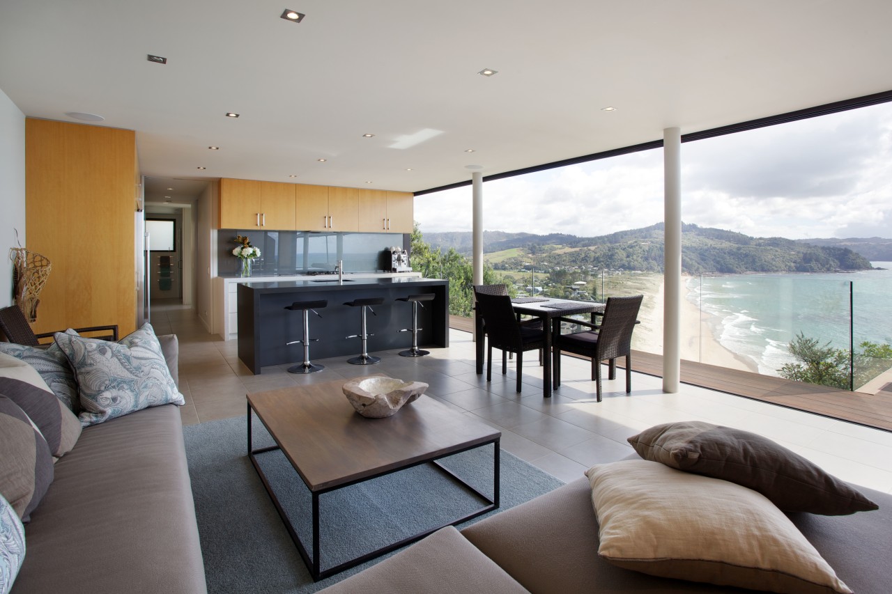 Making the island black was a way to architecture, home, house, interior design, living room, penthouse apartment, property, real estate, window, gray