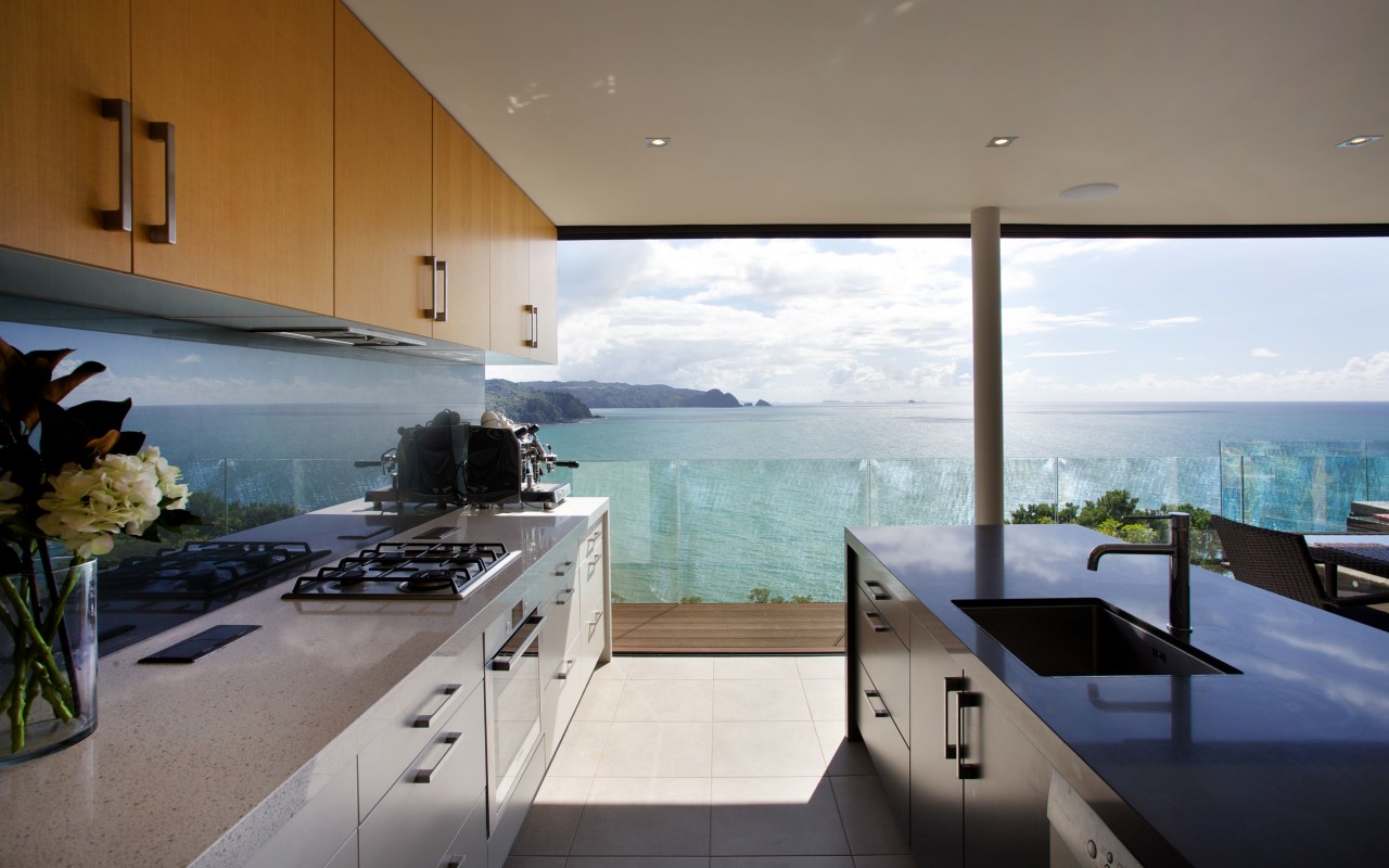 A galley kitchen is positioned at one end apartment, architecture, condominium, countertop, estate, home, house, interior design, penthouse apartment, property, real estate, window, gray