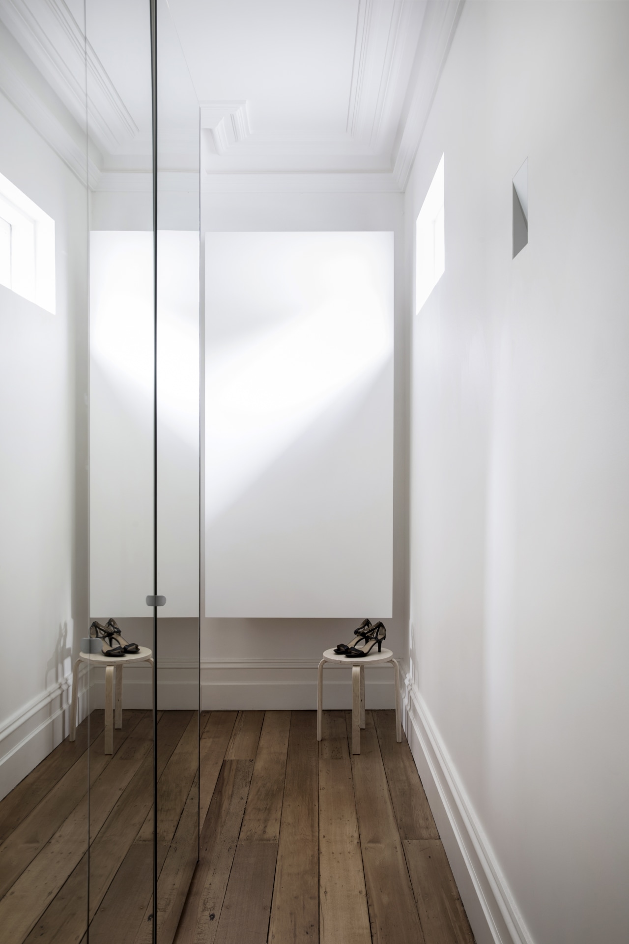 The shoes standing sentry on stools are the architecture, ceiling, daylighting, floor, flooring, house, interior design, wood, white