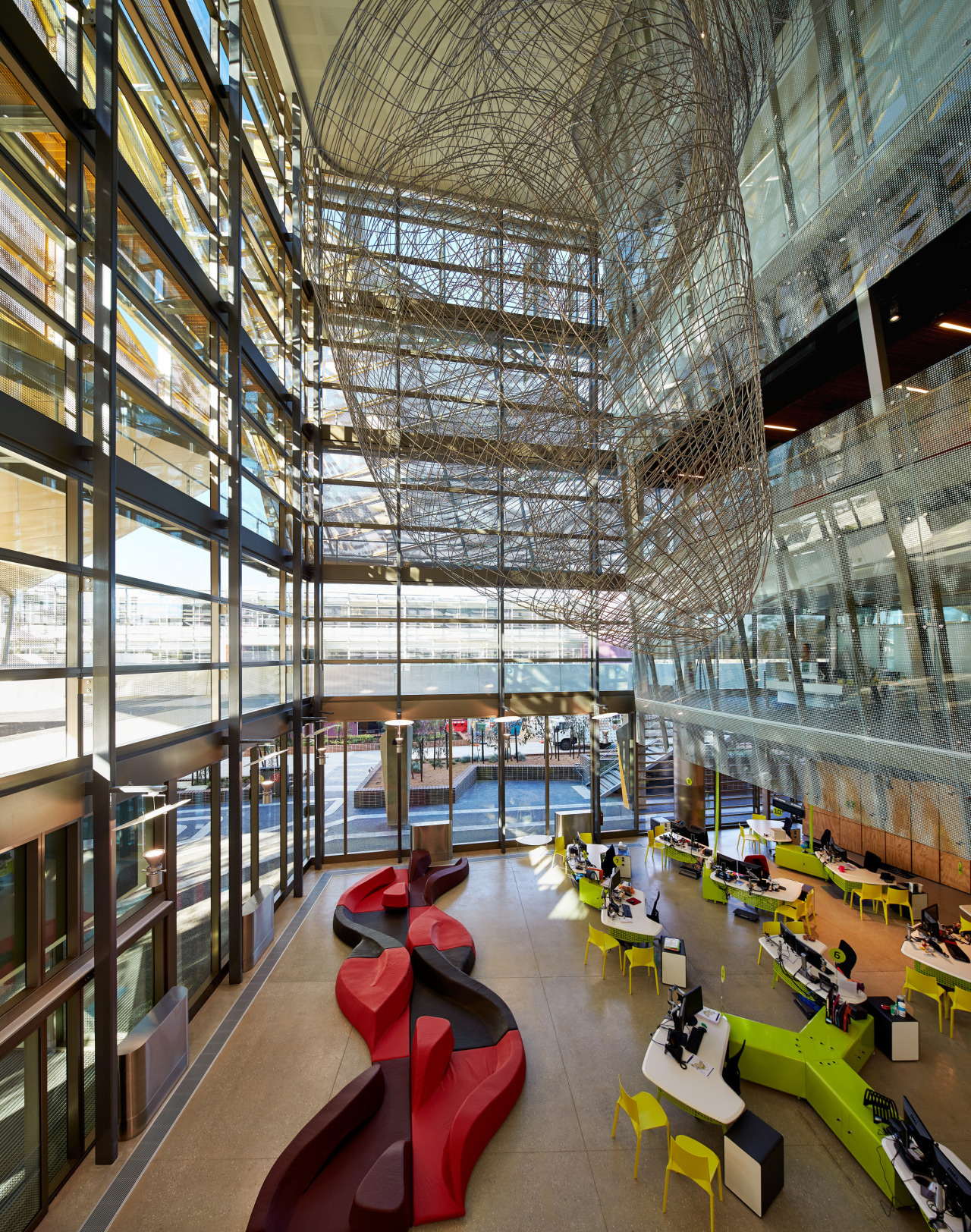 A grand atrium forms a vertical spine on architecture, building, daylighting, institution, interior design, lobby, mixed use, brown