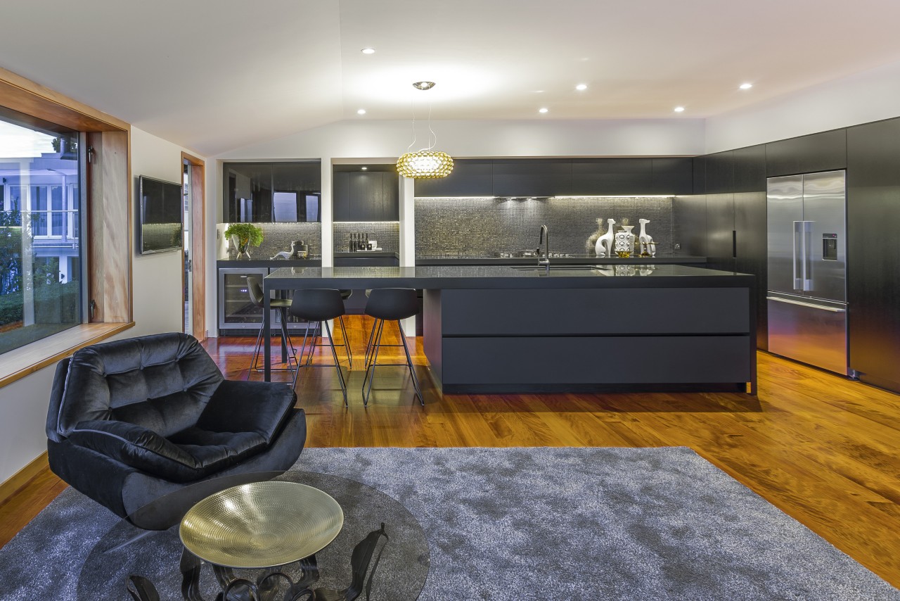 This clean-lined kitchen merges with the wider environment interior design, kitchen, living room, real estate, room, gray, black