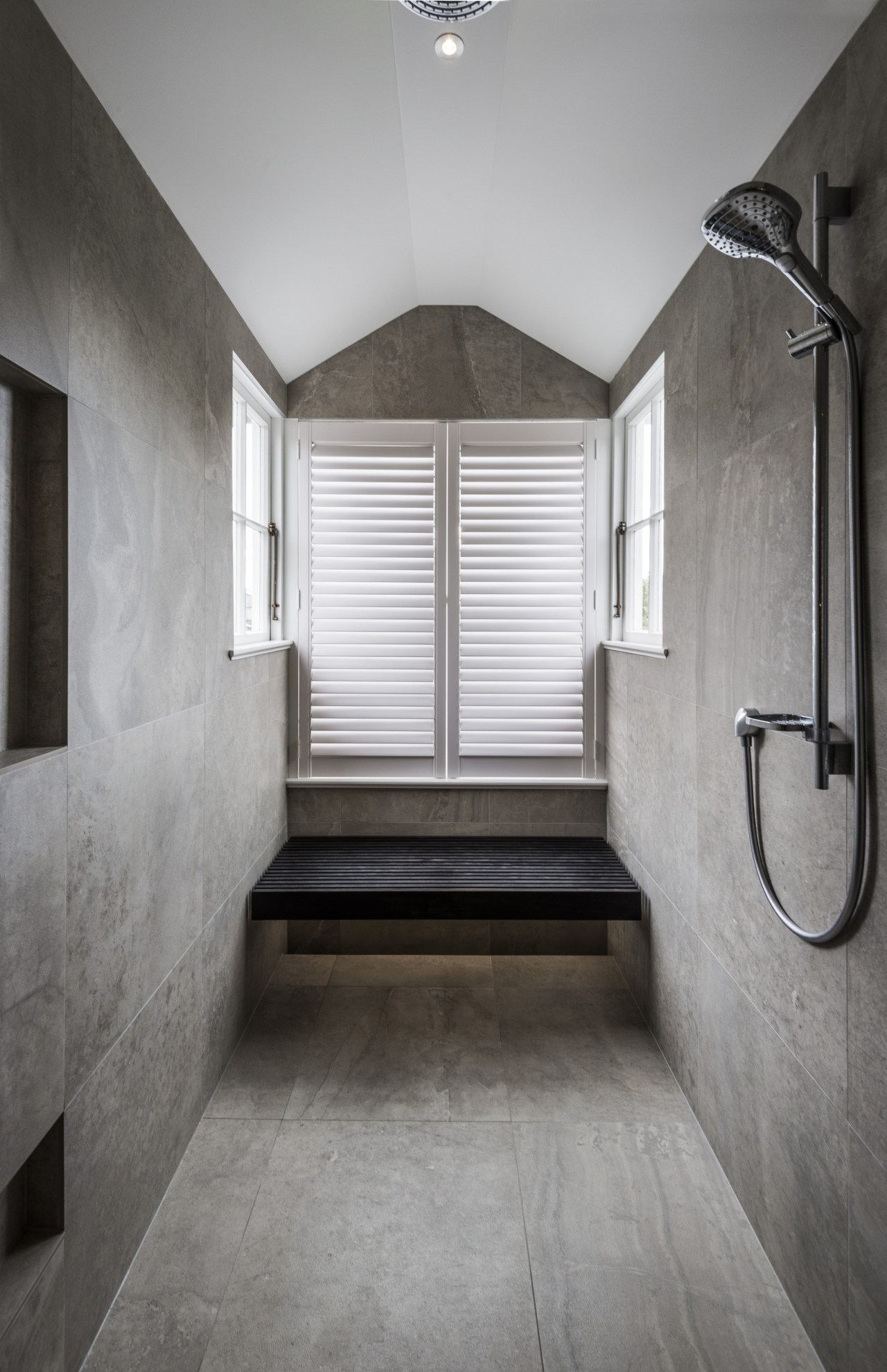 In this under-eaves bathroom, a new double shower architecture, bathroom, ceiling, daylighting, estate, floor, flooring, home, house, interior design, room, tile, gray