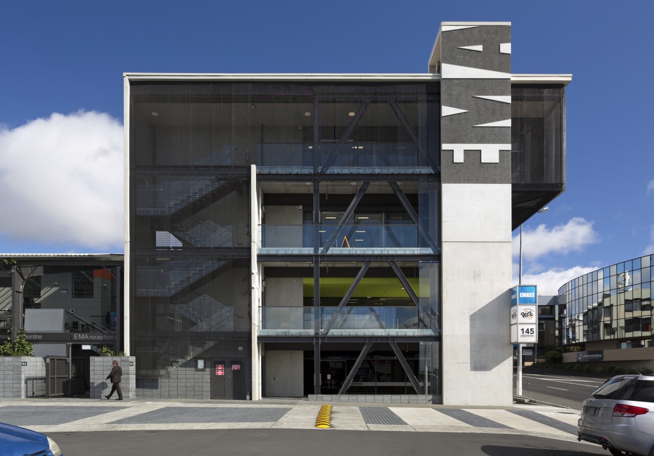 The new EMA head office building is just apartment, architecture, brutalist architecture, building, commercial building, condominium, corporate headquarters, elevation, facade, headquarters, metropolitan area, mixed use, parking, real estate, sky, black, blue