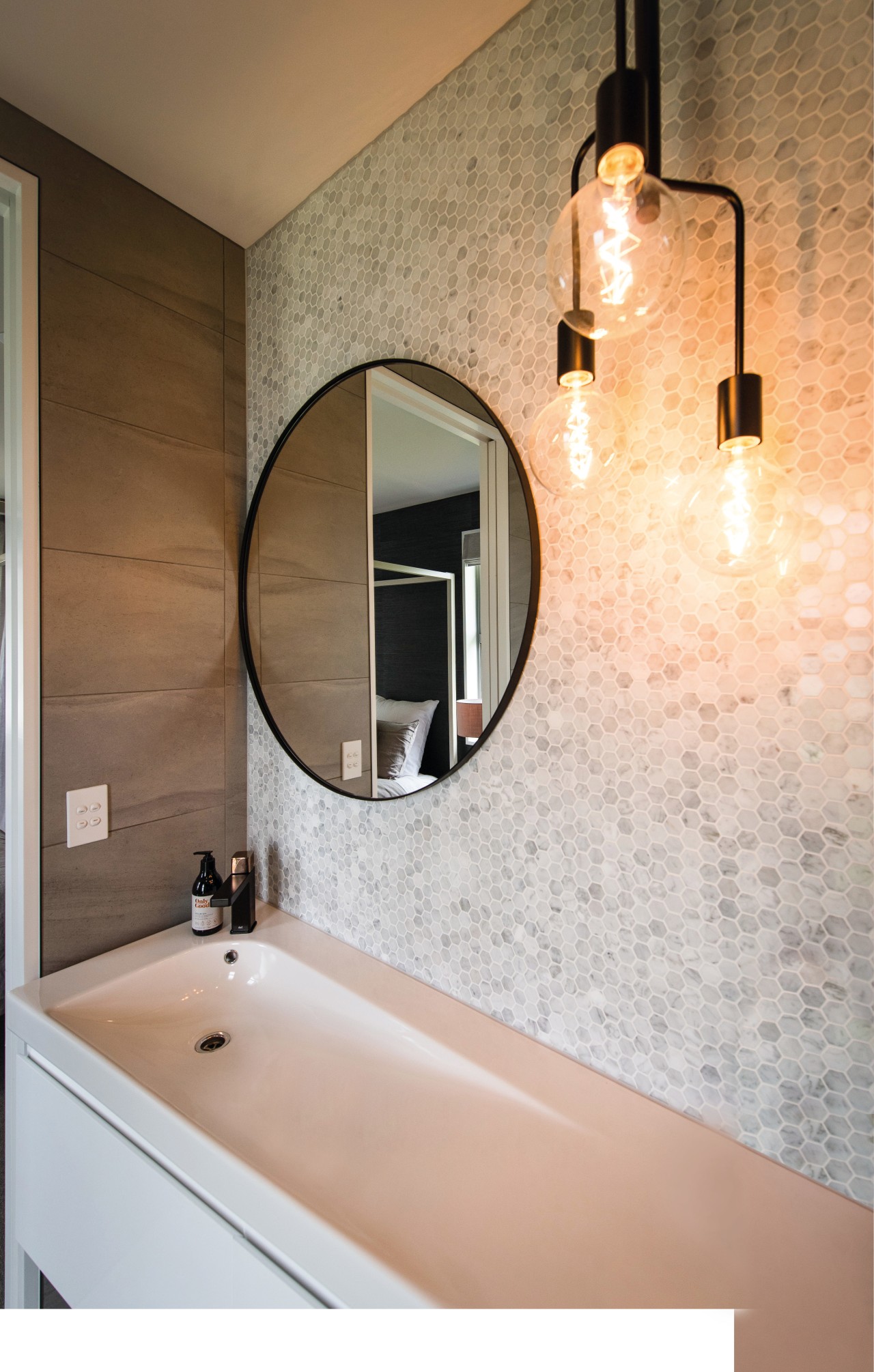 Designer lighting and a feature wall set off bathroom, home, interior design, lighting, room, sink, wall, brown, white