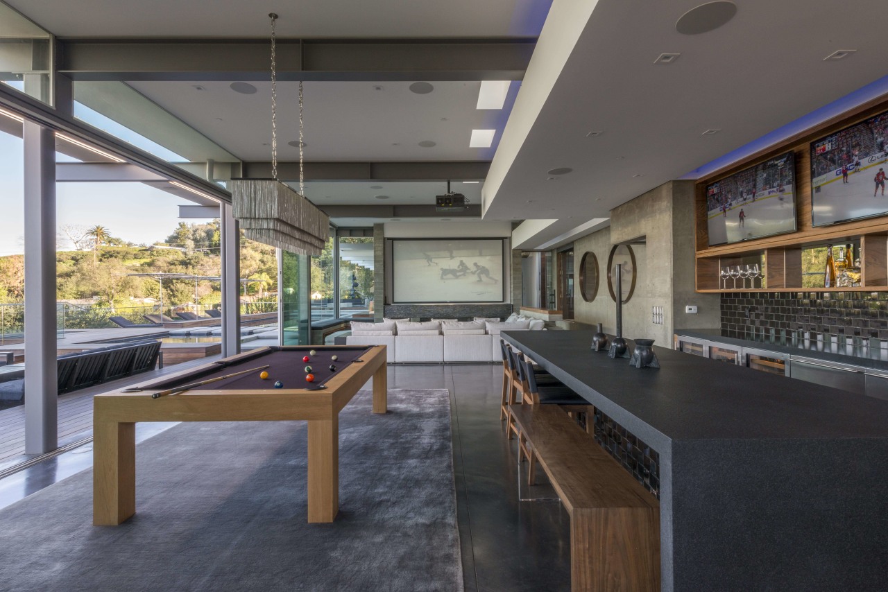 The dropped ceiling in this large, poolside entertaining interior design, real estate, table, gray, black