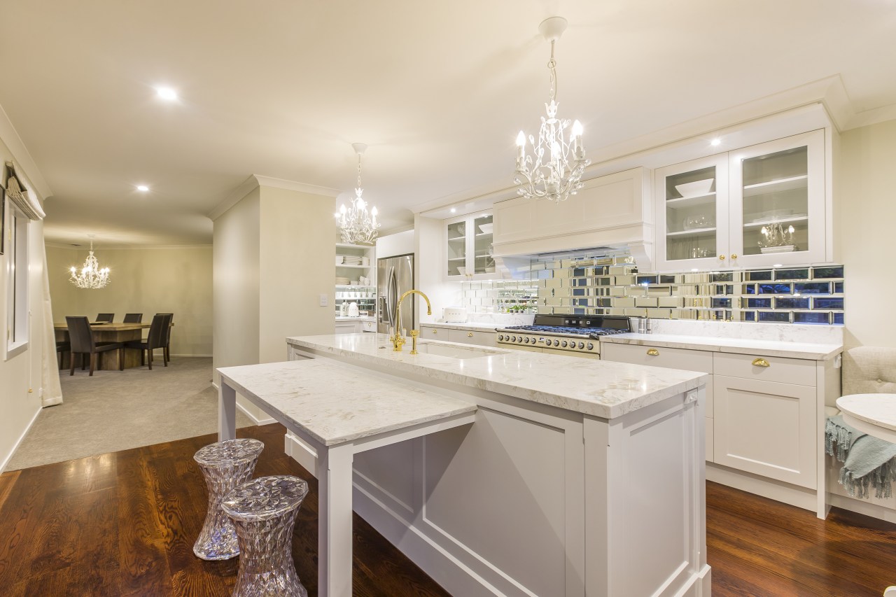 Crystal chandeliers, modern crystal-look stools, and shiny brass cabinetry, countertop, cuisine classique, estate, home, interior design, kitchen, property, real estate, room, gray