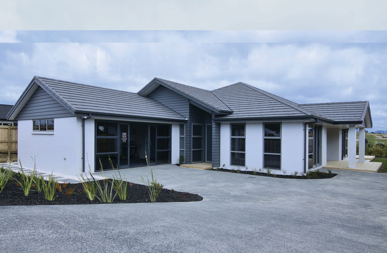 An attractive sand-bagged brick facade and textured, pressed home, house, property, residential area, teal