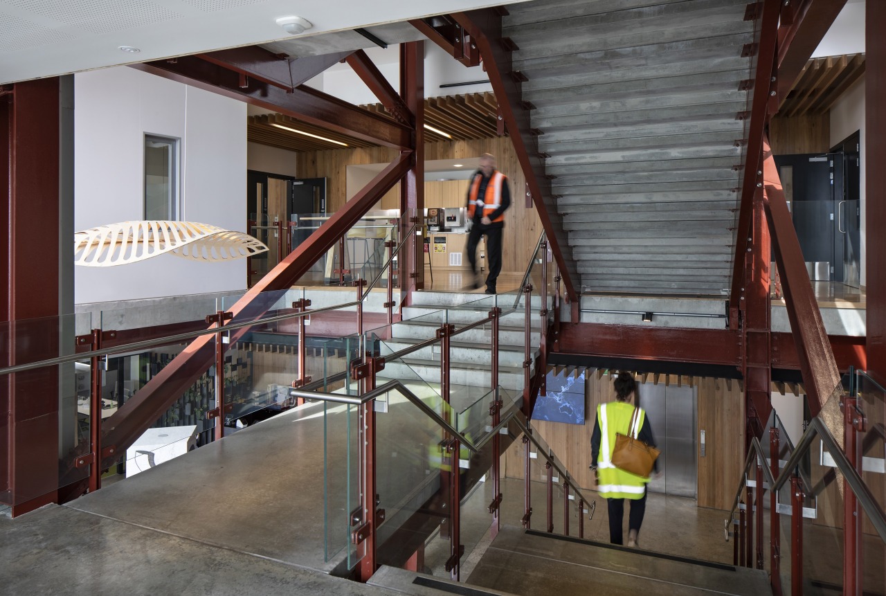 The interior palette at Lyttleton Port's Waterfront House architecture, beam, building, ceiling, daylighting, floor, handrail, ladder, lobby, loft, room, stairs, gray, red