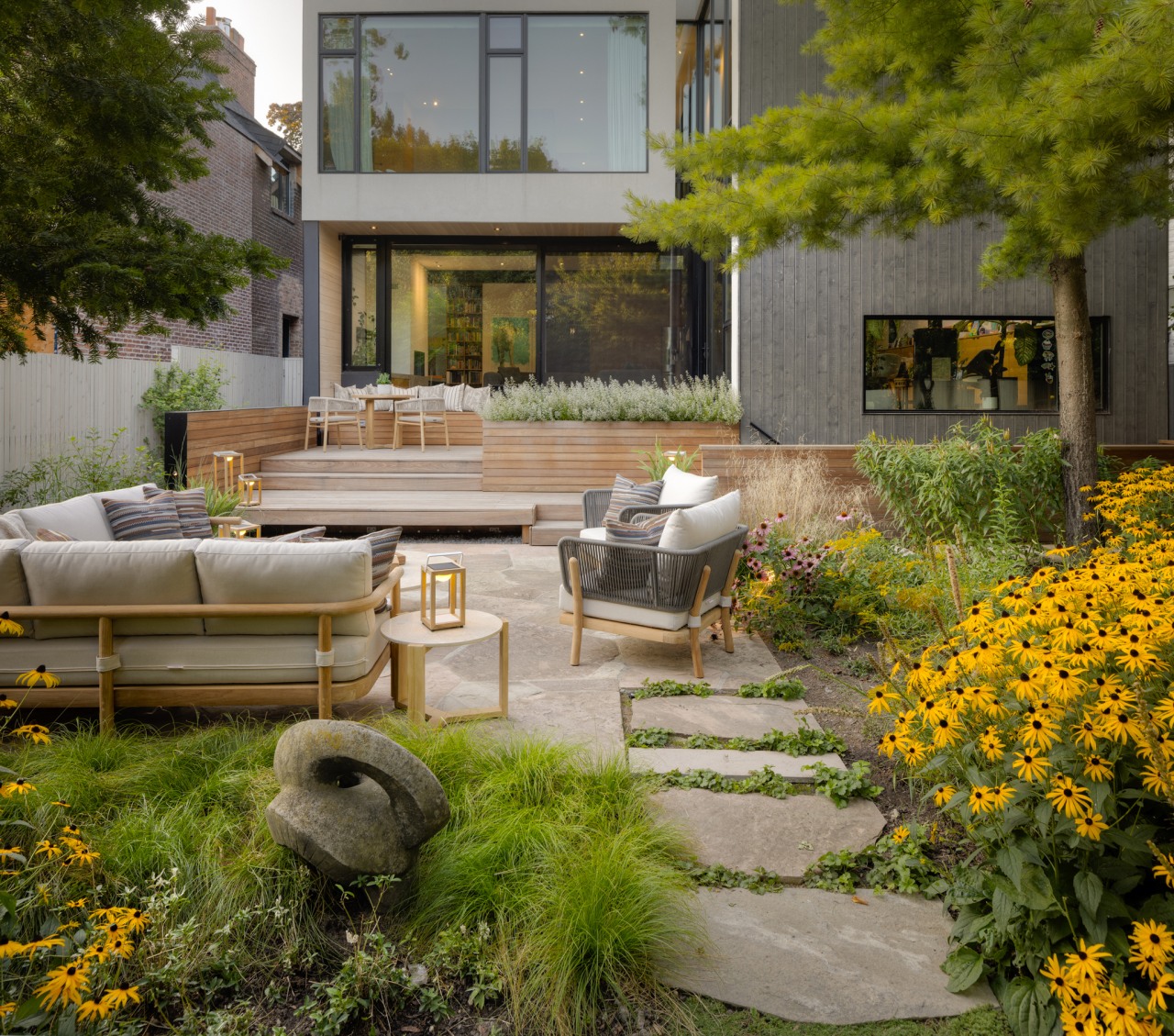 This multi-level dining/​entertaining zone features an ipe wood 