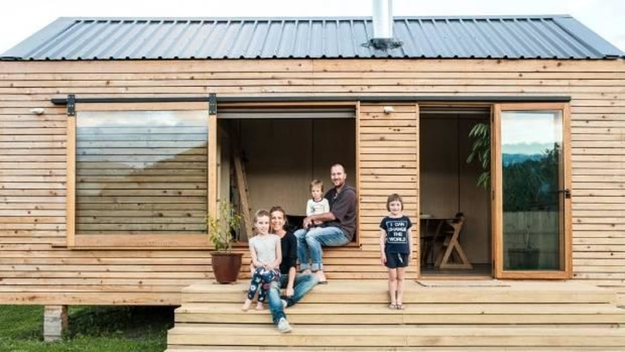 Francois and Sarah-Lee Guittenit of Nelson in cottage, home, house, log cabin, shack, shed, siding, window, wood, orange