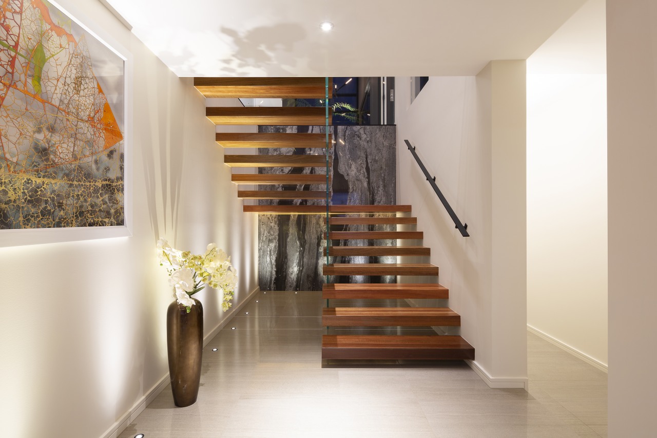 The open timber stairs at front entry. - 