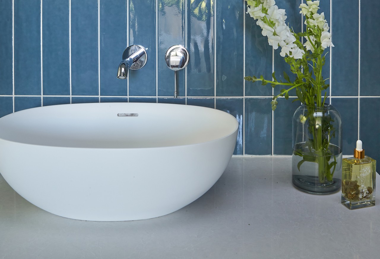 A slender benchtop and tabletop basin evoke a 