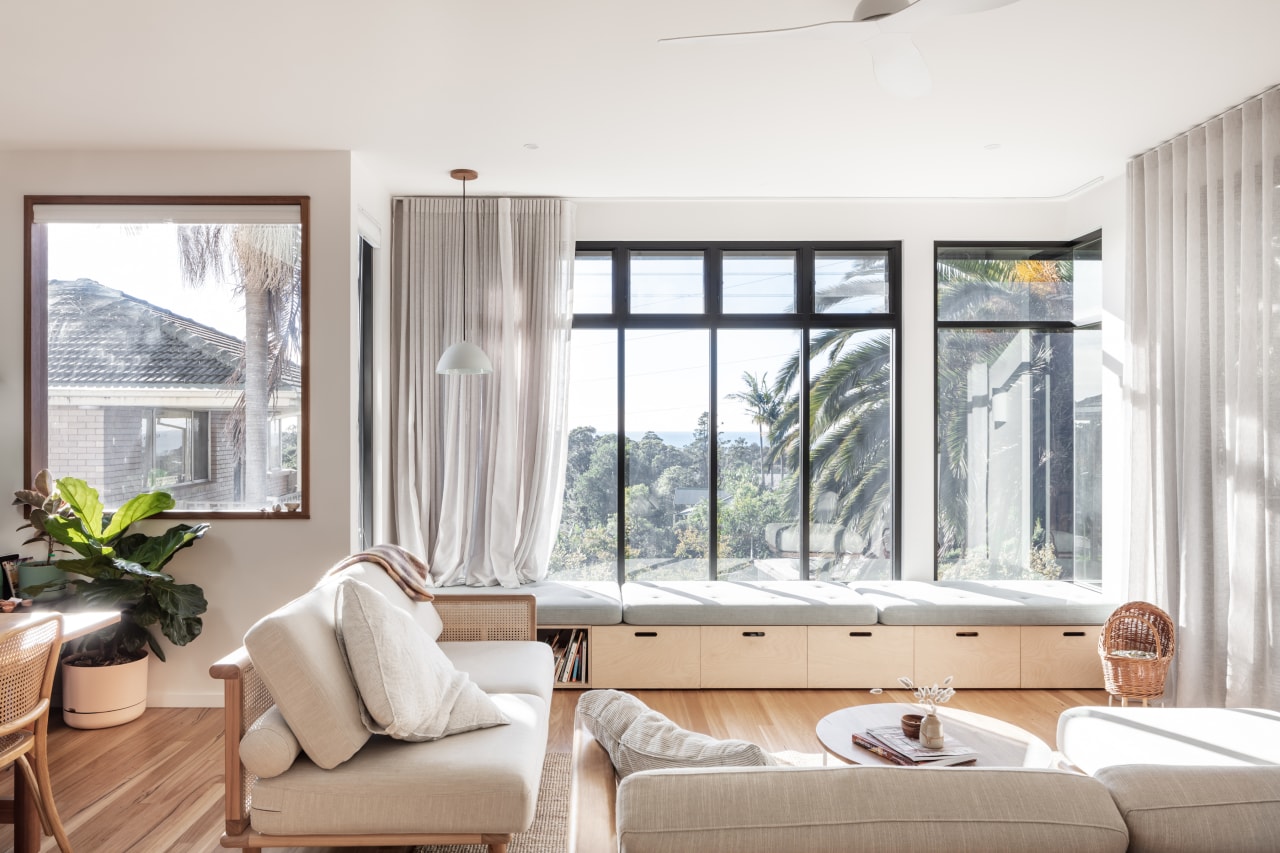 Consecutive vertical windows above the daybed frame the 