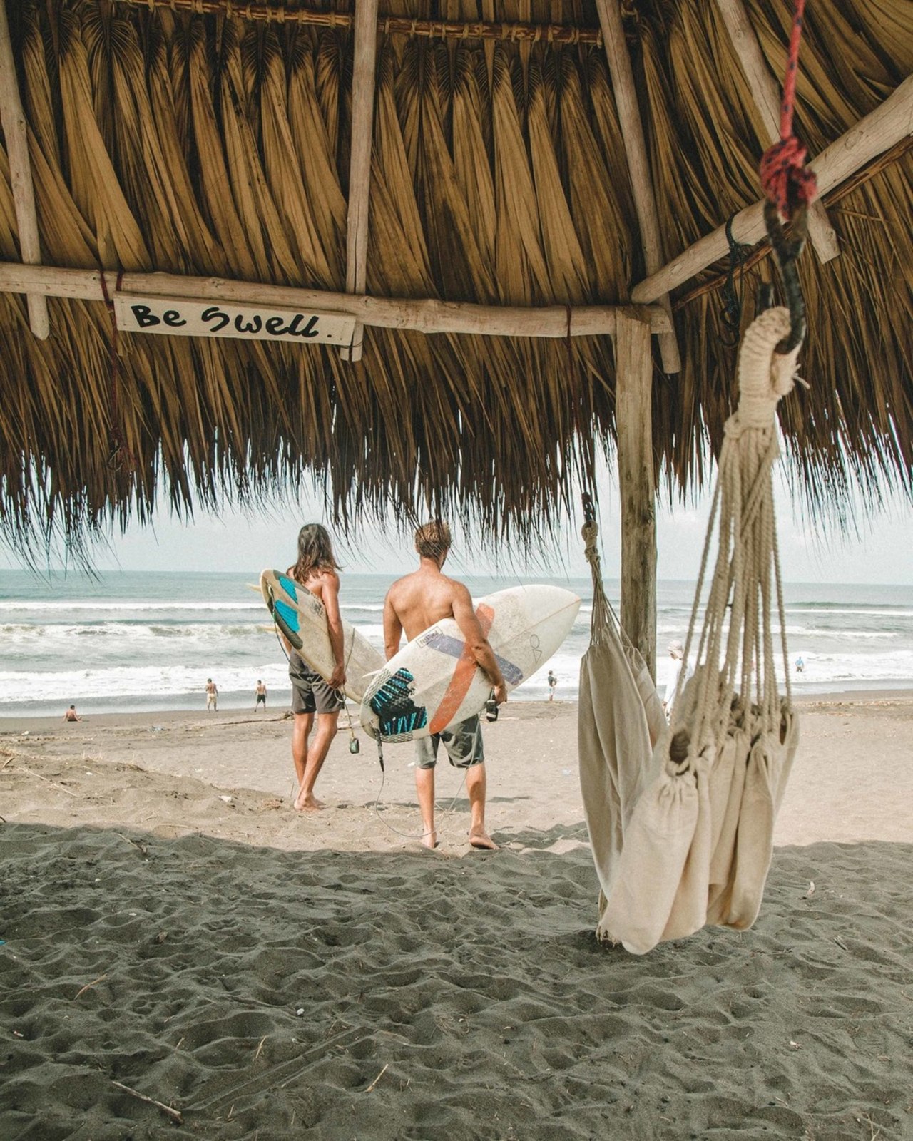 The combination of endless authentic black sand beach, beach, caribbean, fun, hammock, leisure, ocean, people on beach, sand, sea, summer, tourism, tree, tropics, vacation, brown, gray