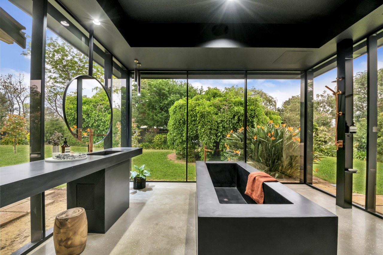 The black concrete custom bath is internally heated. 