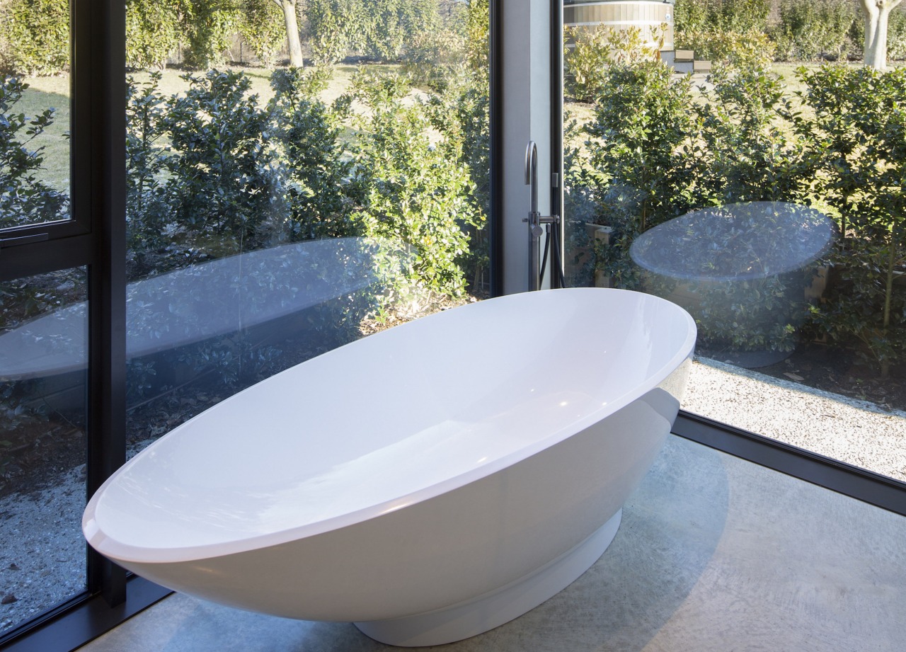 A comfortable tub, underfloor heating and giant windows 