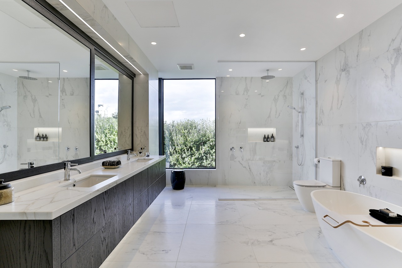 In the master bathroom, a large vanity extending gray