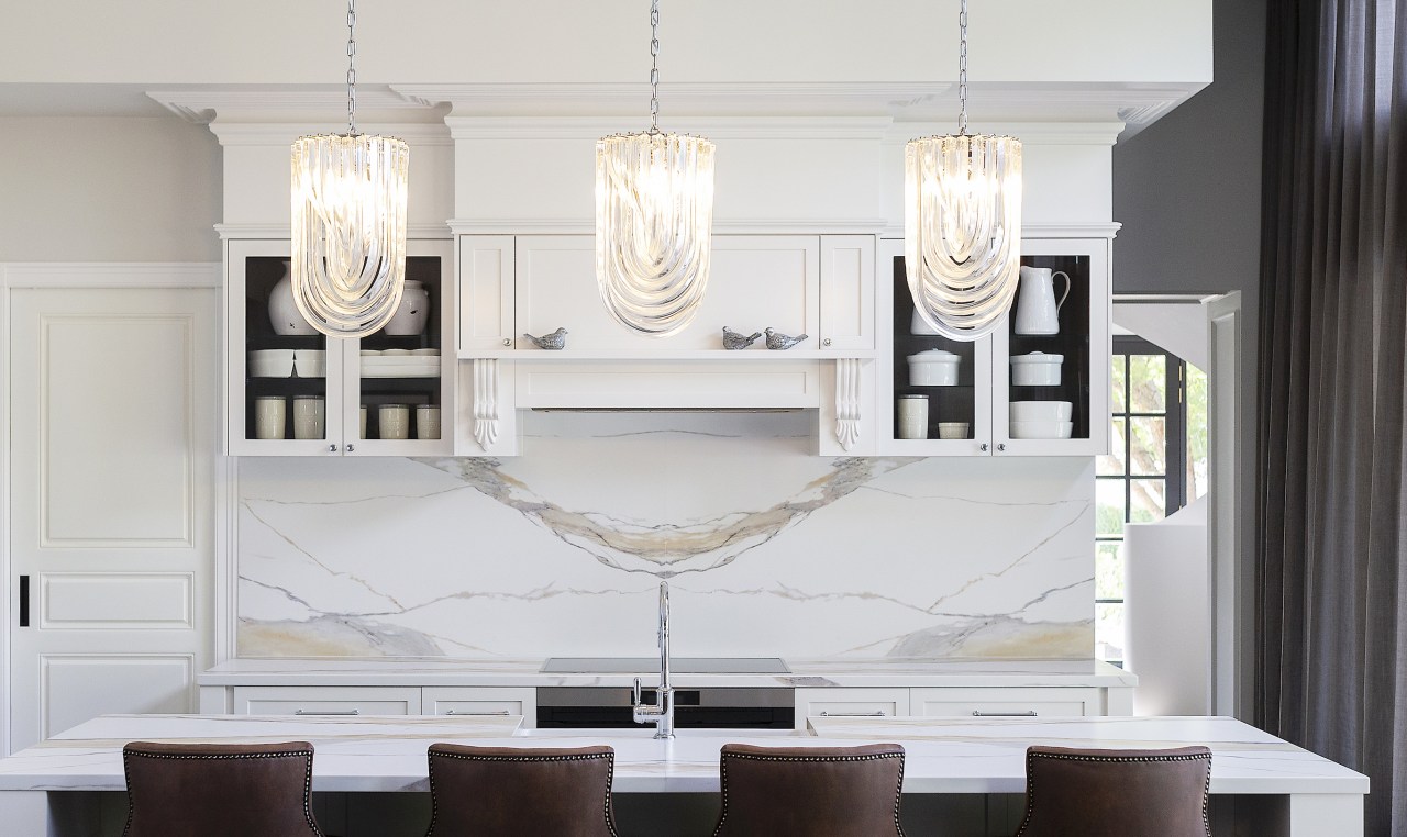 Panelled kitchen cabinetry and a marble splashback add 