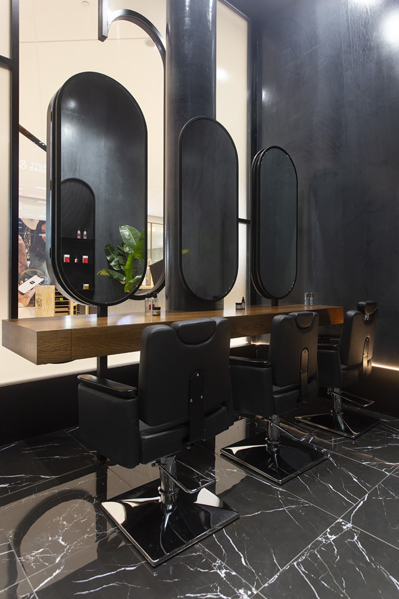 The fit-out creates an immersive environment removed from architecture, building, design, floor, flooring, furniture, interior design, living room, room, table, black