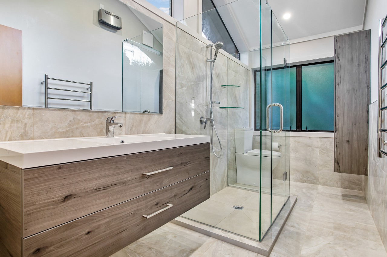 The EJ Building renovation places the shower in architecture, bathroom, bathroom accessory, bathtub, building, ceiling, estate, floor, flooring, furniture, glass, home, house, interior design, material property, plumbing fixture, property, real estate, room, tap, tile, wall, gray