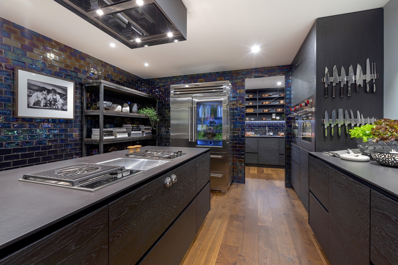 Matt black surfaces are teemed with shiny appliances black, gray