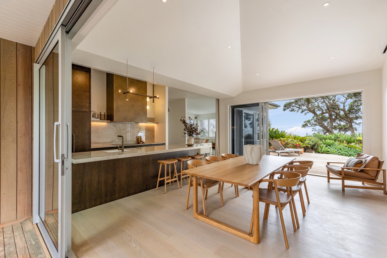 The kitchen and dining areas enjoy open indoor-outdoor 