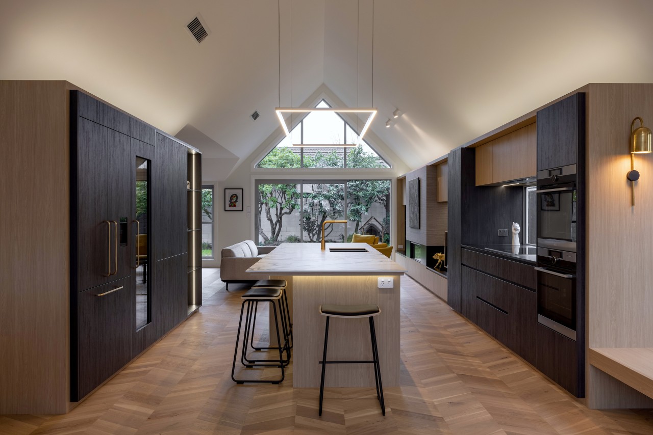 Refined cabinetry, integrated appliances, a sculptural island and 