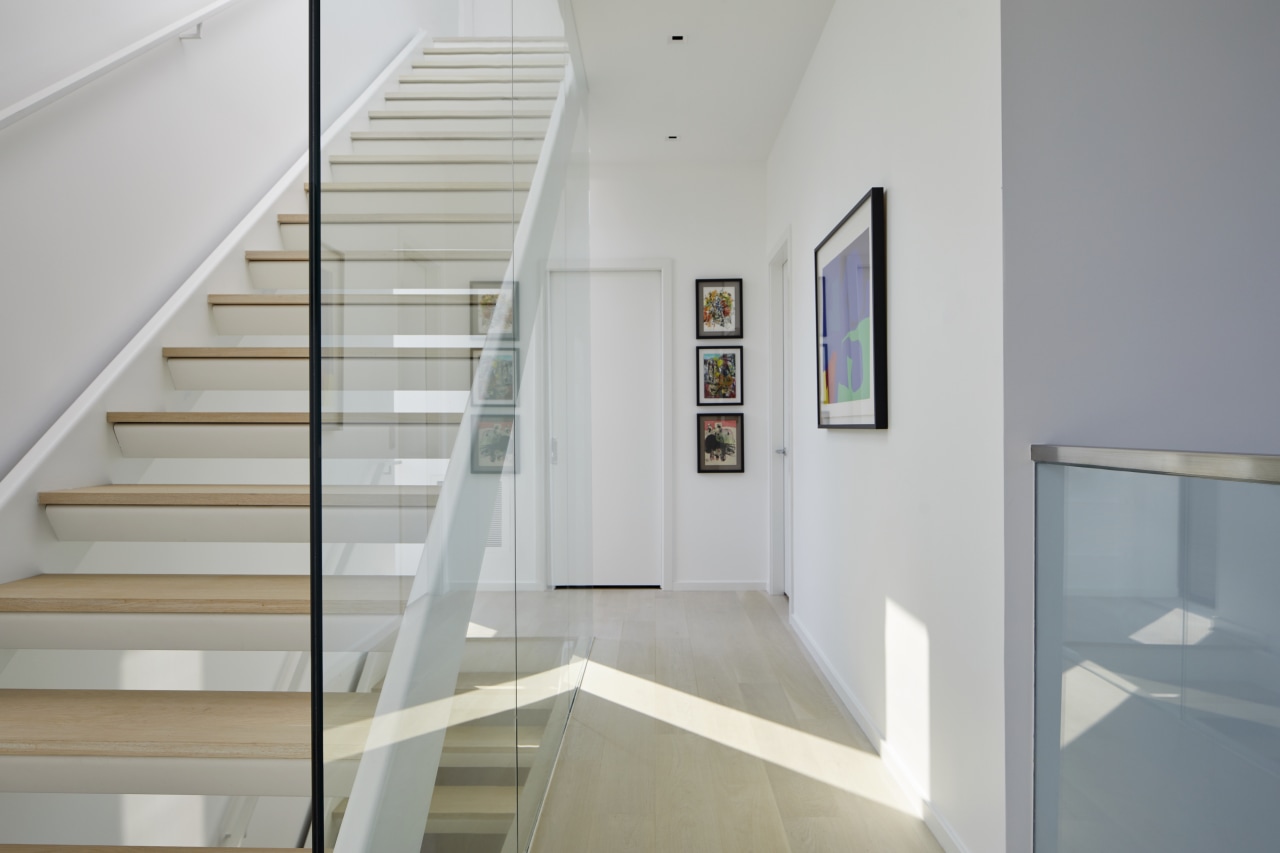 The main staircase complete with feature glass balustrade. 