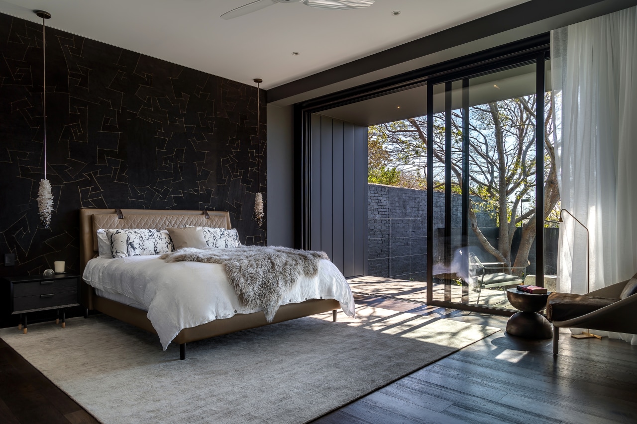 Floor-to-ceiling sliders open the master bedroom up up 