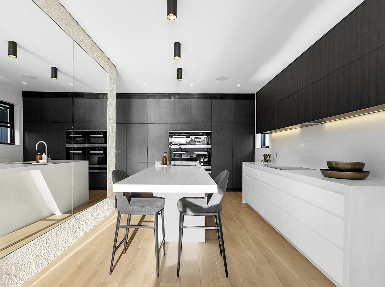 Black and white kitchen surfaces are grounded by 