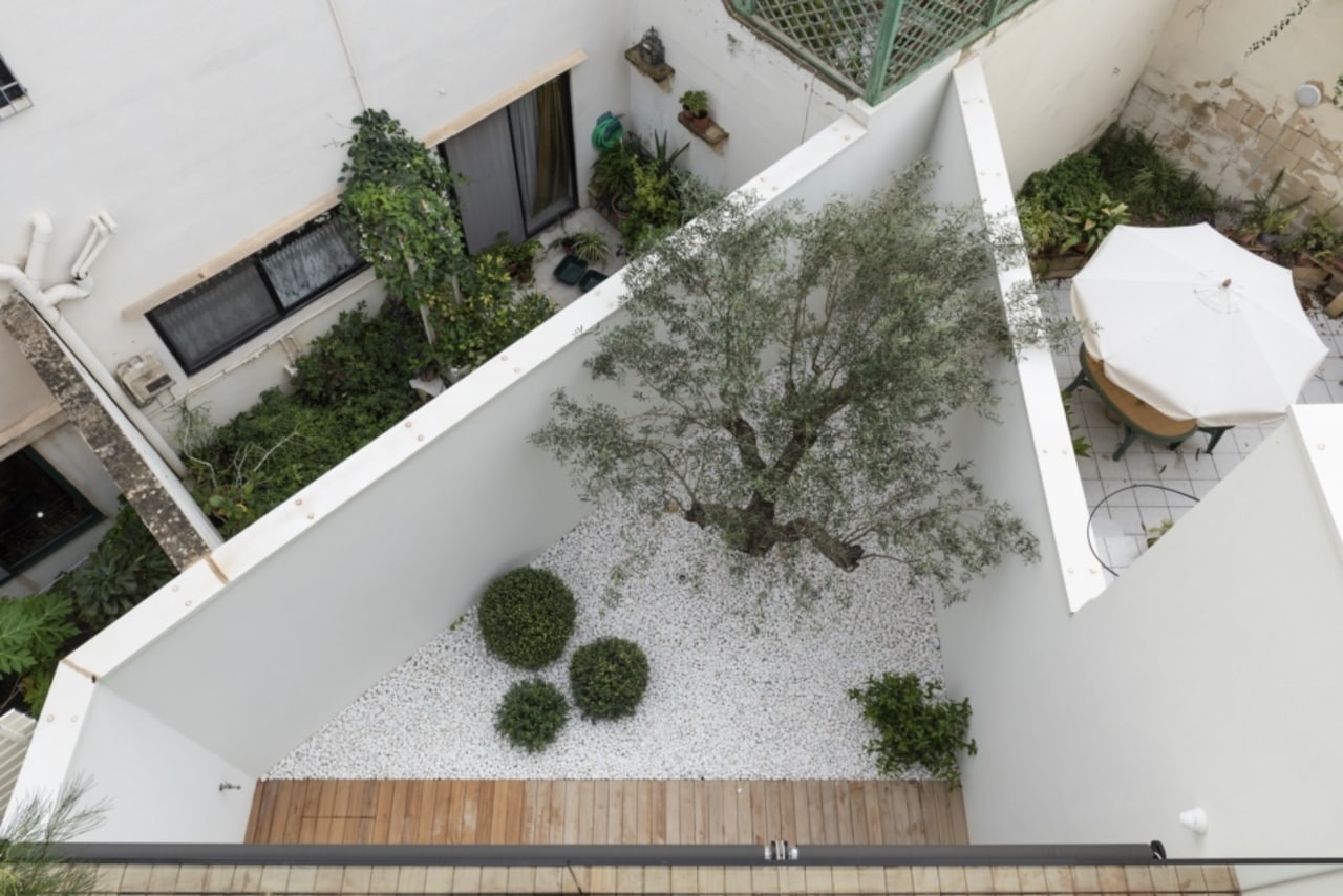 The home includes an outdoor courtyard at the architecture, building, courtyard, floor, grass, home, house, landscape, plant, property, real estate, roof, room, urban design, gray, outdoor living