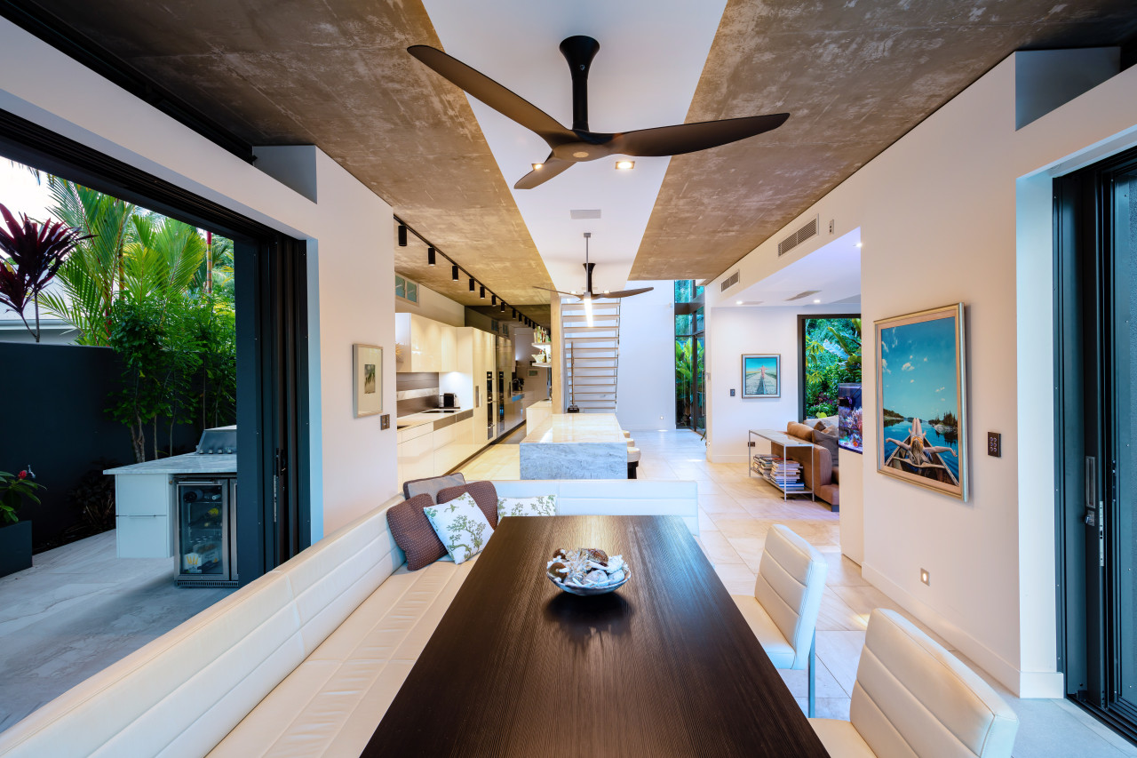 ​​​​​​​Large stacker doors open these living areas to architecture, daylighting, estate, home, house, interior design, living room, real estate, gray